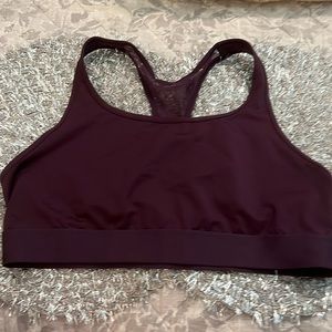 A purple Victoria’s Secret sports bra and a size extra large